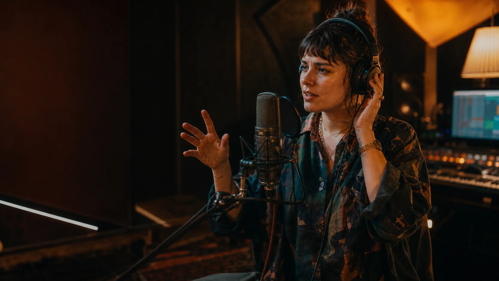 Vocalist describing a sound while recording in a modern studio